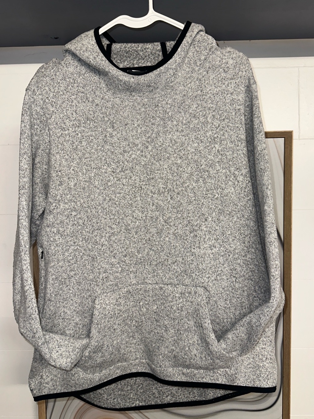Nike Therma Fit Women’s Light Gray Hoodie Sweater with Black Trim.
